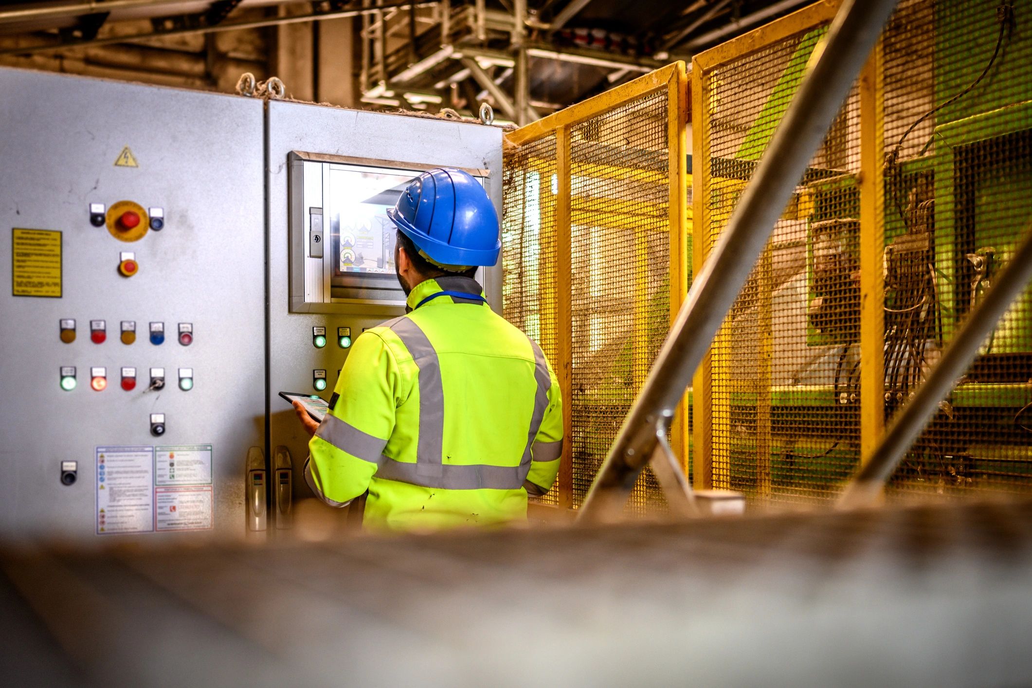 Technician monitoring an industrial control panel
