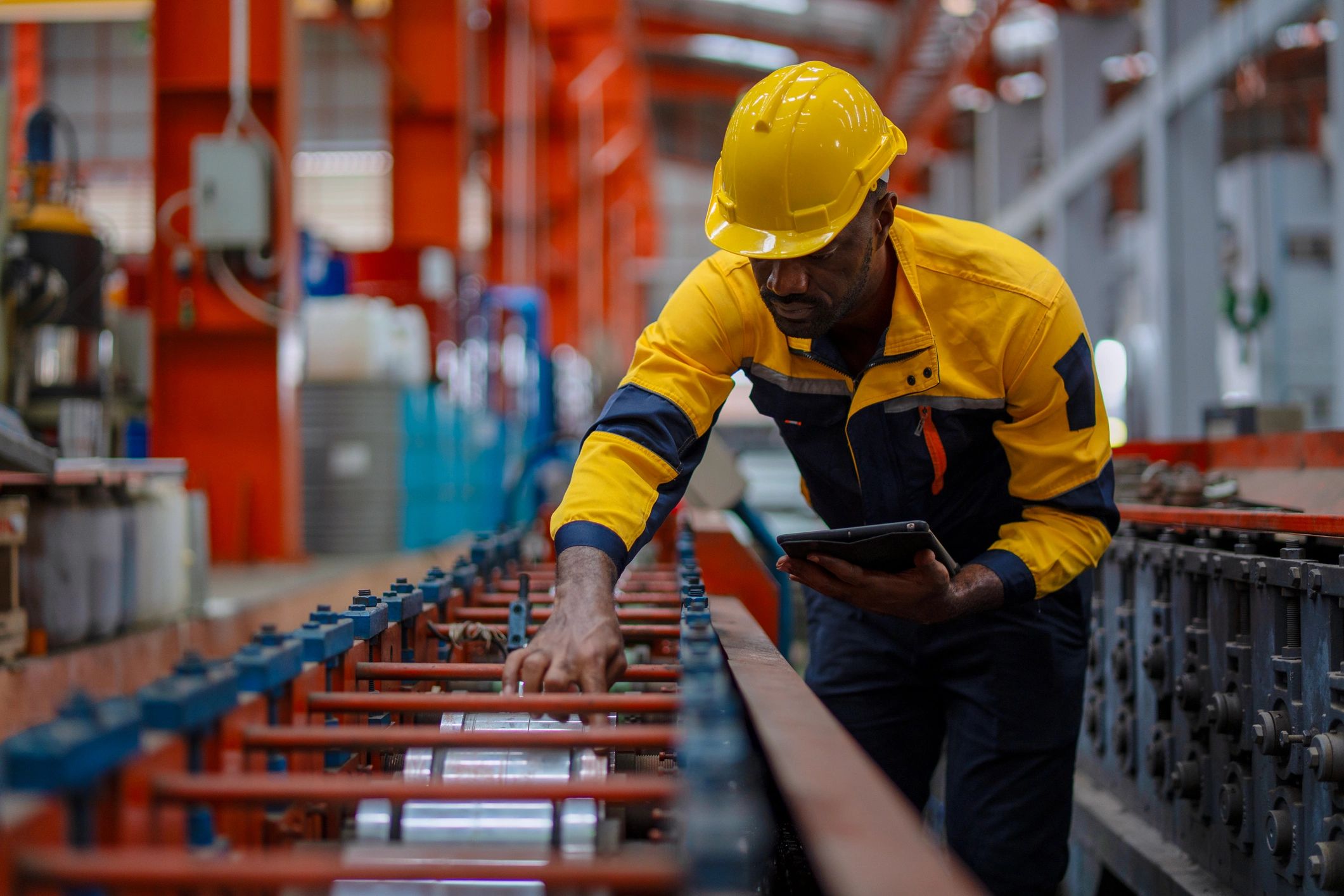 Industrial technician working with factory equipment