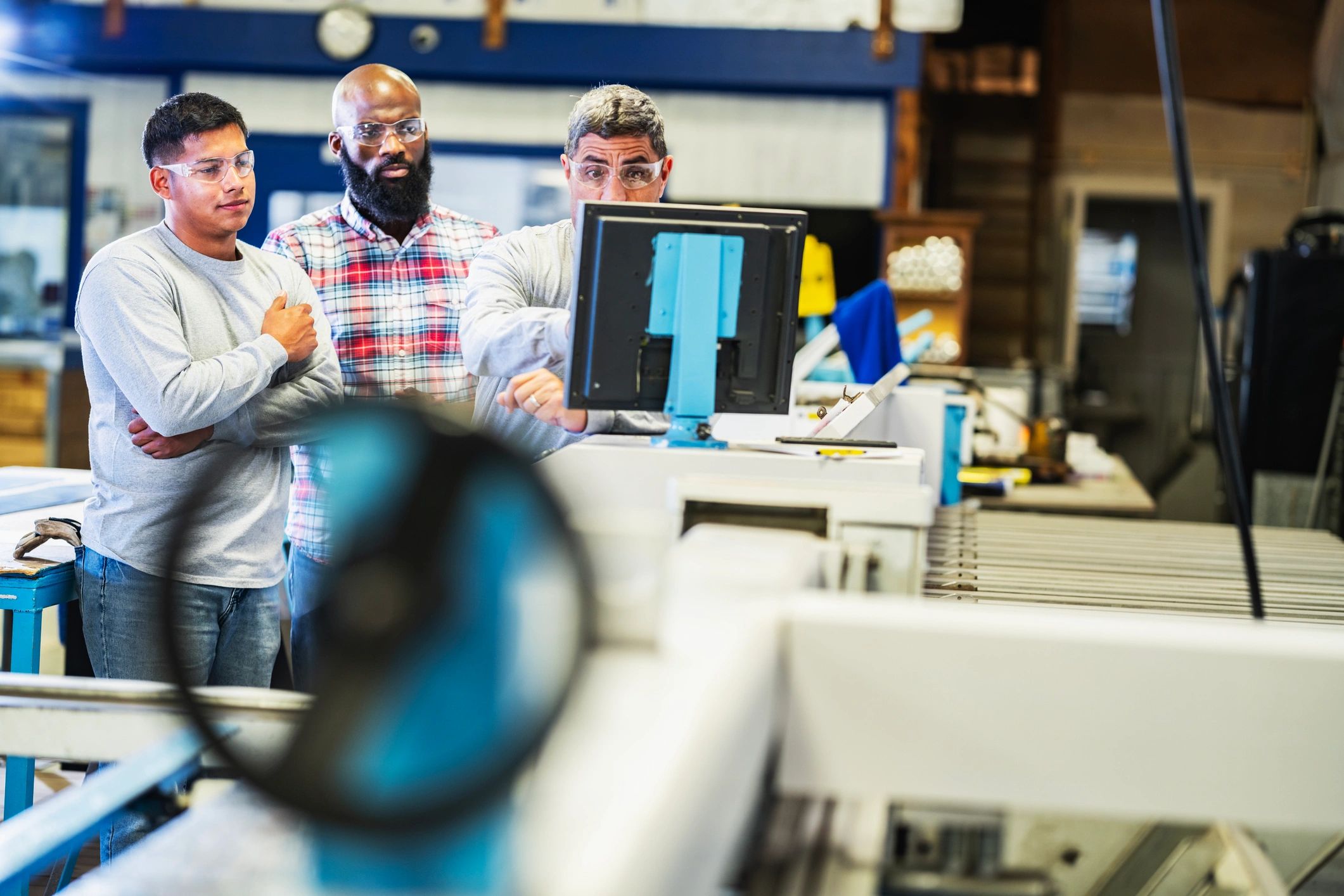 Technicians learning to operate industrial equipment